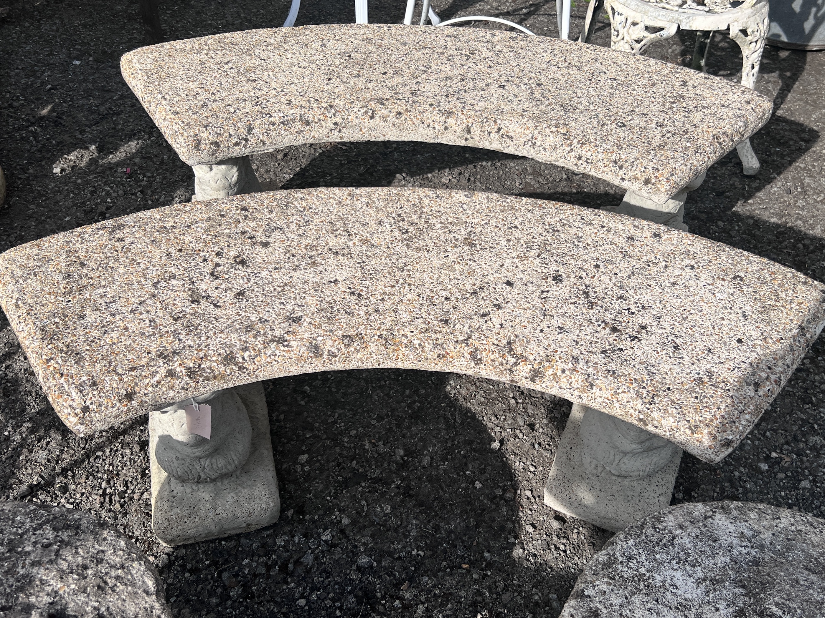 A pair of curved reconstituted stone garden benches, width 122cm, height 45cm